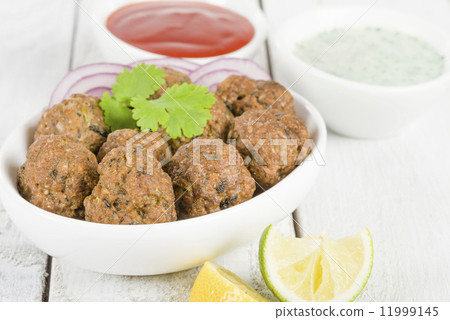 Kofta - South Asian spicy meatballs garnished with green chilies and red onions. Kofta - South Asian spicy meatballs garnished with green chilies and red onions. 11999145