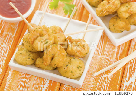 Crispy Prawns Skewers - Asian style fried battered prawns on skewers served with sweet chili dip. 11999276