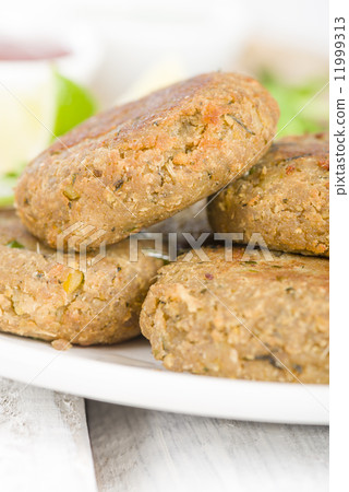 Shami Kebab - Minced meat and chana dal patties stuffed with red onion pickle. Shami Kebab - Minced meat and chana dal patties stuffed with red onion pickle. 11999313