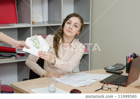 Business woman takes a bribe in an envelope 11999560