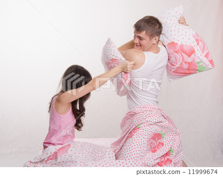 Husband beats his wife pillow Husband beats his wife pillow 11999674