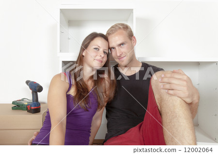 Young Couple Moving In Together Young Couple Moving In Together 12002064
