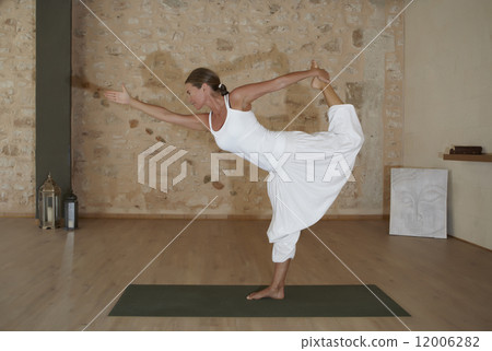 Woman doing yoga exercise 12006282