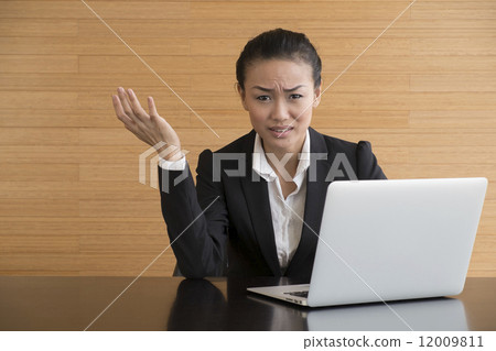 Asian Business Woman indoor with laptop computer 12009811