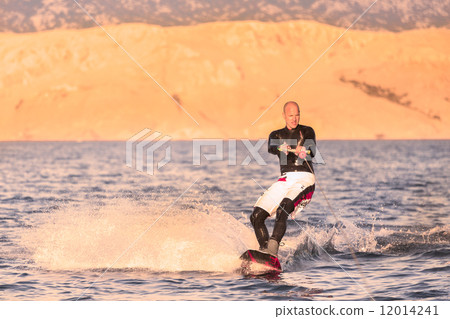 Wakeboarder in sunset. 12014241
