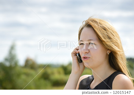 Beautiful caucasian girl talking to smart phone 12015147