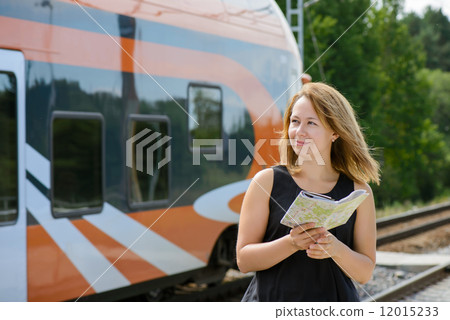 Girl holding map and watching on a train 12015233