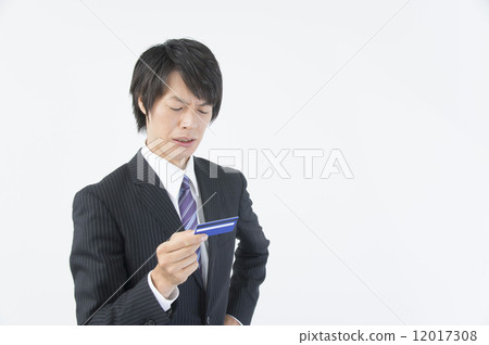 Businessman looking at failed credit card Businessman looking at failed credit card 12017308