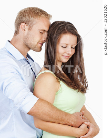 Portrait of a Happy Young Couple Embracing 12021620