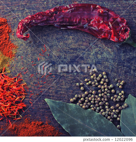 Spices on a old wooden cutting board 12022096