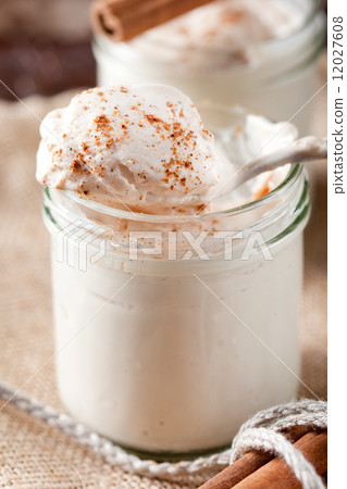 Baked milk yogurt with cinnamon in glass jars 12027608
