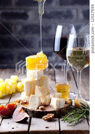 Cheese plate with honey, grape, wine in glasses Cheese plate with honey, grape, wine in glasses 12027699