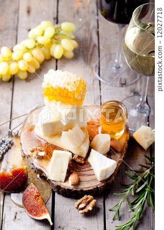 Cheese plate with honey, grape, wine in glasses 12027718