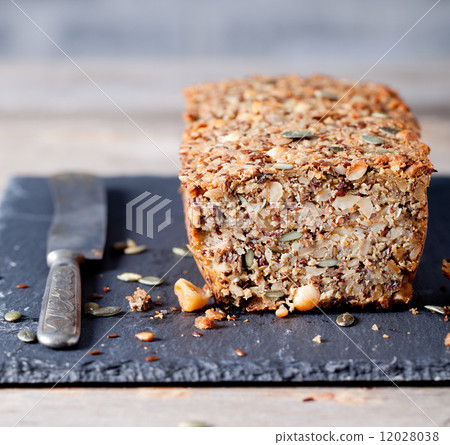 Wholegrain bread with seeds on a stone plate 12028038