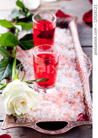 Rose flavor liqueur in shot glasses on pink salt 12028121