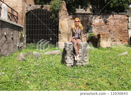 Attractive girl near the picturesque ruins of Rome, Italy 12030643
