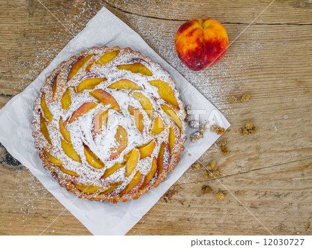 Peach pie on a wooden desk Peach pie on a wooden desk 12030727
