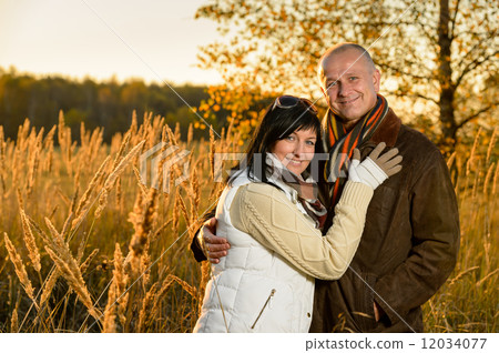 Couple embracing in autumn countryside sunset Couple embracing in autumn countryside sunset 12034077