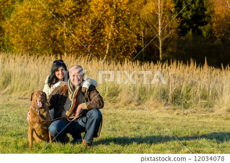 Cheerful couple with dog in autumn countryside Cheerful couple with dog in autumn countryside 12034078