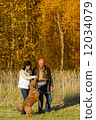Couple playing with dog autumn sunset park 12034079
