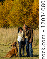 Couple training dog autumn sunset park 12034080