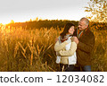 Couple hugging during autumn sunset countryside 12034082