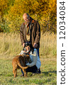 Couple playing with dog sunny autumn park 12034084