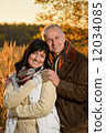 Romantic couple embracing in autumn sunset park 12034085