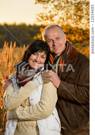 Romantic couple embracing in autumn sunset park Romantic couple embracing in autumn sunset park 12034085