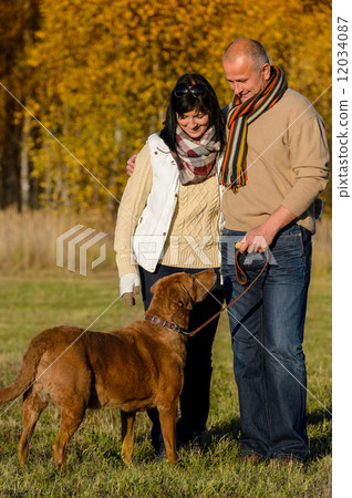 Couple with dog in sunny autumn park Couple with dog in sunny autumn park 12034087