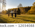 Couple walking dog autumn sunset landscape 12034088