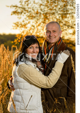 Romantic couple hugging autumn sunset countryside Romantic couple hugging autumn sunset countryside 12034093