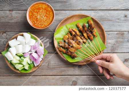 People eating satay 12037577