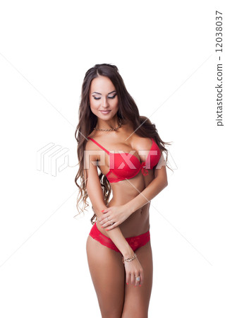 Flirtatious tanned model posing in red lingerie 12038037