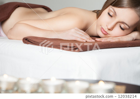 woman in spa salon lying on massage desk 12038214