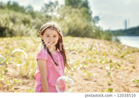 Portrait of merry little girl posing at camera 12038510