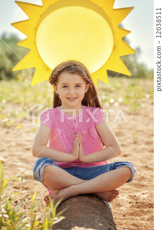 Image of adorable little girl in lotus position 12038511