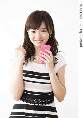 A young woman operating a smartphone A young woman operating a smartphone 12041510
