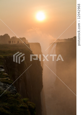 Victoria Falls sunset with tourist in the cliff Victoria Falls sunset with tourist in the cliff 12042968