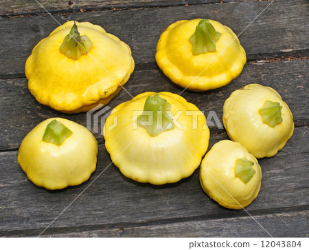 Yellow Patissons on a wooden table 12043804