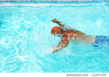 Man in swimming pool Man in swimming pool 12047195