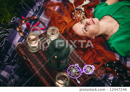 Beautiful red hair woman lying in grass Beautiful red hair woman lying in grass 12047246