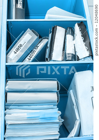 Stack of paper in bookcase 12048690