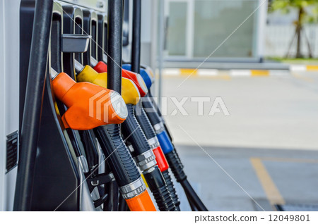 Horizontal shot of some fuel pumps at a gas station 12049801