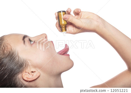 woman with a homeopathic globules on the tip of her tongue, isol 12051221