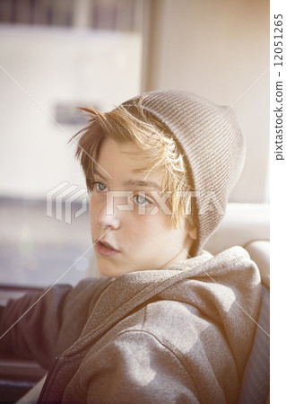 portrait of a teenager boy with toque, sitting in a bus portrait of a teenager boy with toque, sitting in a bus 12051265