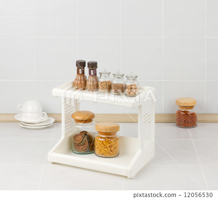 Plastic shelf with seasonings bottles 12056530