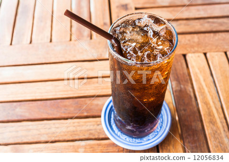 Fresh black soda with ice on wood table 12056834