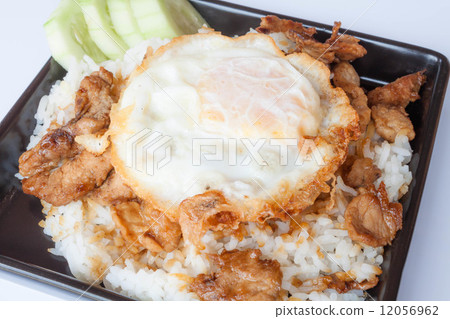 Egg fried and fried pork garlic with soy sauce topped on rice Egg fried and fried pork garlic with soy sauce topped on rice 12056962