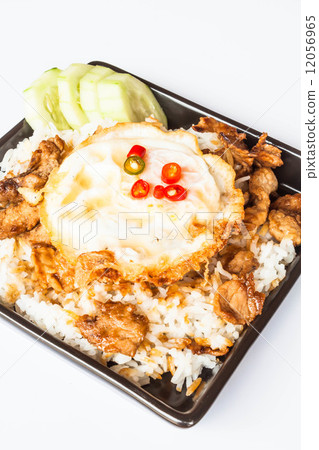 Egg fried and fried pork garlic with soy sauce topped on rice Egg fried and fried pork garlic with soy sauce topped on rice 12056965